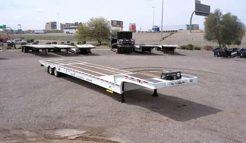 White Landoll trailer in a gravel lot.