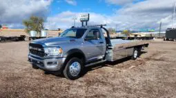 Silver Ram 5500 tow truck with flatbed.