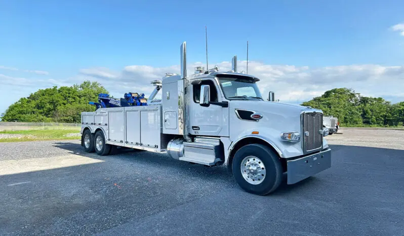 White tow truck parked in lot.