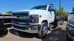 White Chevrolet Silverado tow truck.