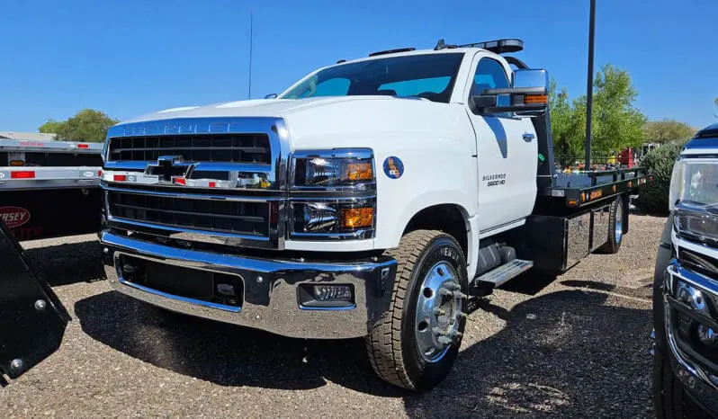 White Chevrolet Silverado tow truck.