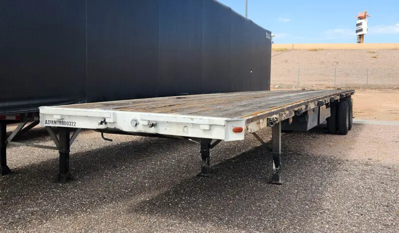 White flatbed trailer with black wheels.