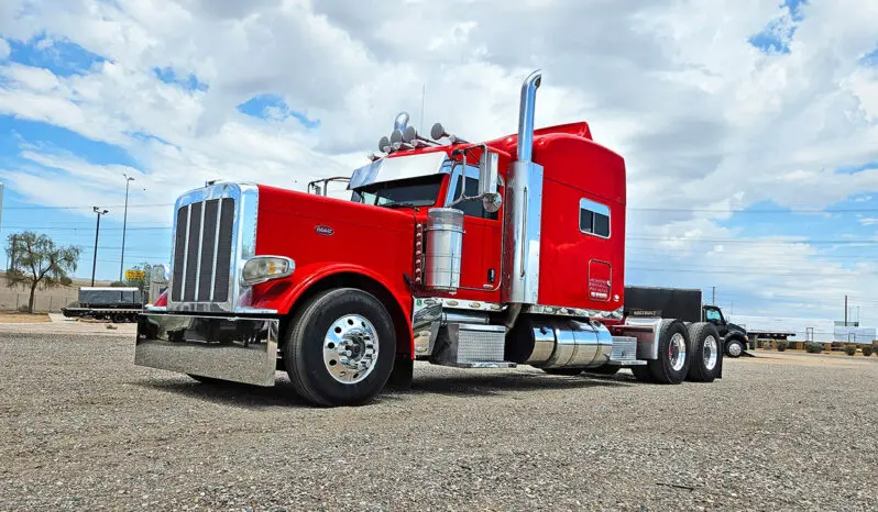 Red semi-truck parked in a lot.