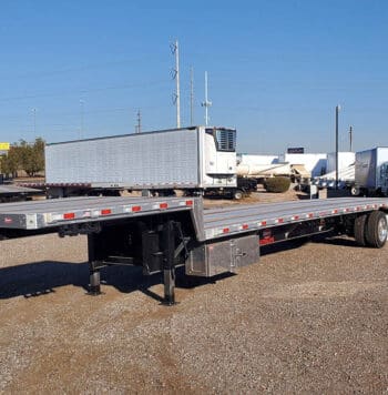 Flatbed semi trailer parked in a commercial vehicle lot