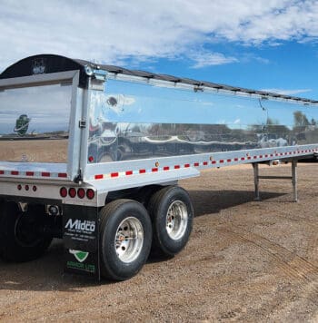 Silver semi-trailer with black tarp.