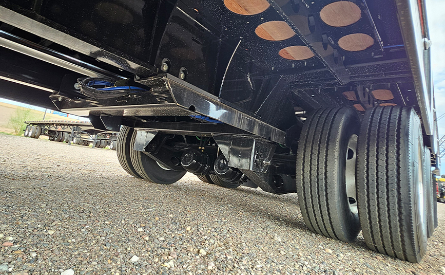 Landoll-930E-51-15-hydraulic-traveling-tail-trailer-for-sale-14-underside-trailer-axles-tires