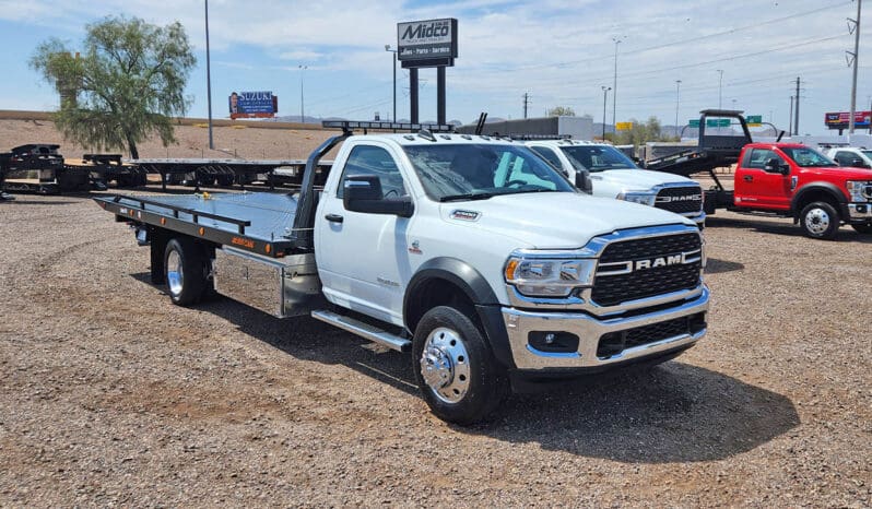 White Ram 5500 flatbed tow truck.