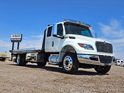 2025 international mv607 jerr-dan rollback tow truck - 01 - front view, passenger side