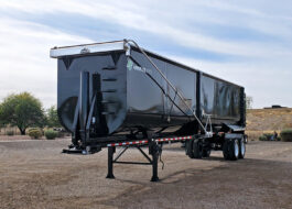 armor light high side demo end dump trailer - 01 - front, side angled view
