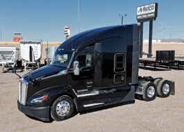 2022 kenworth T680 black sleeper cab truck - 01 - driver side view