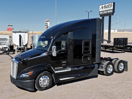 2022 kenworth T680 black sleeper cab truck - 01 - driver side view
