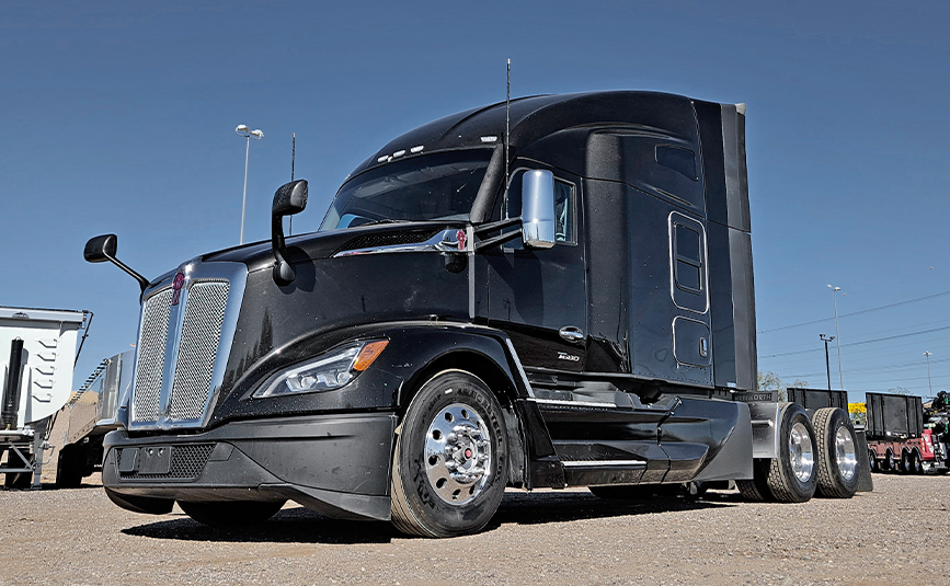 2022 kenworth T680 black sleeper cab truck - 02 - front grill, side angle view