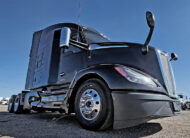 2022 kenworth T680 black sleeper cab truck - 07 - driver side front tire and wheel